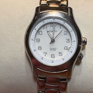 31 Timex Indiglo WR 30M watch with a stainless steel band and a white dial